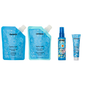 Amika hydro rush shampoo texture on palm, demonstrating gentle lather and moisture-rich formula