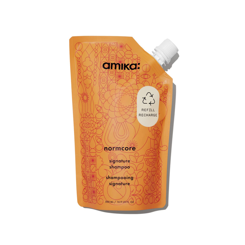 Amika bottle front label showcasing Normcore Signature Shampoo benefit