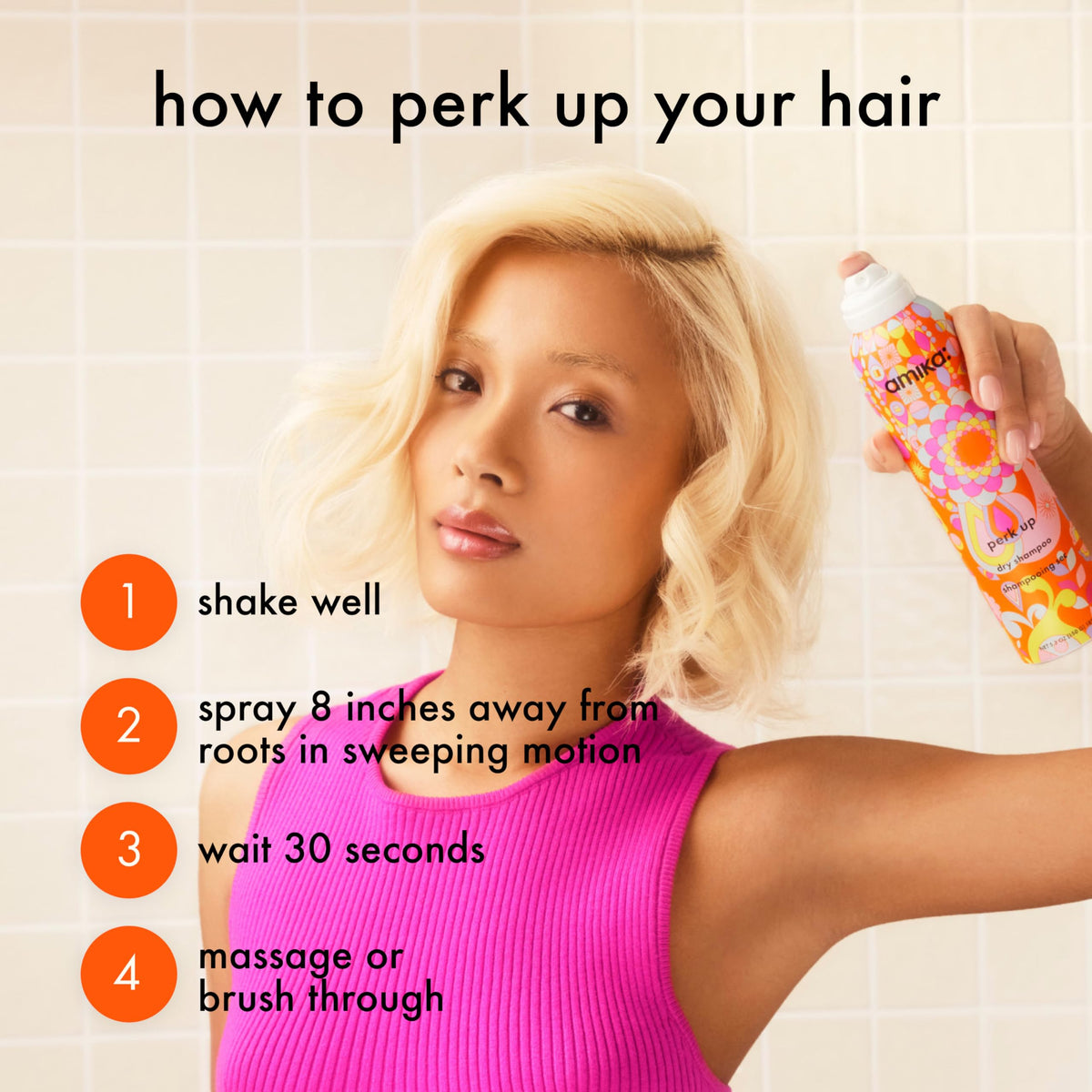 Spray mist landing on roots with Amika Perk Up creating instant oil absorption