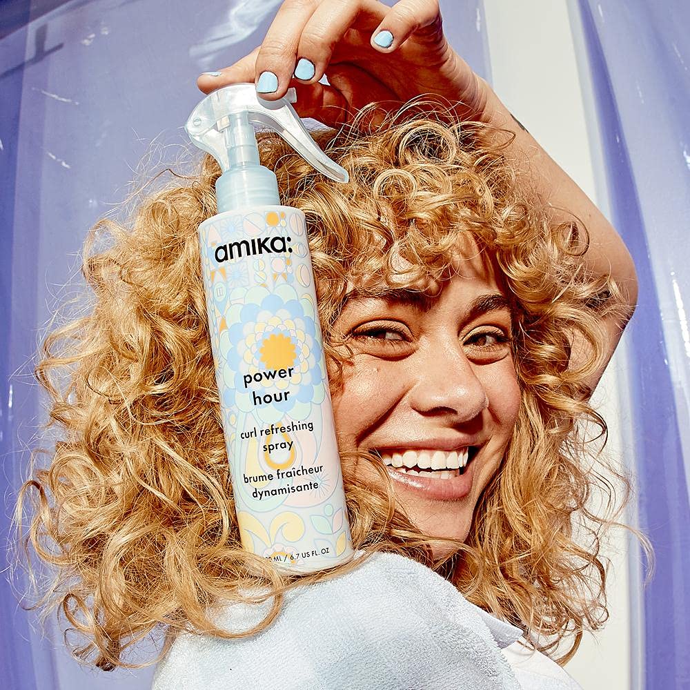 amika used on curly hair in bathroom demonstrating at-home refresh routine