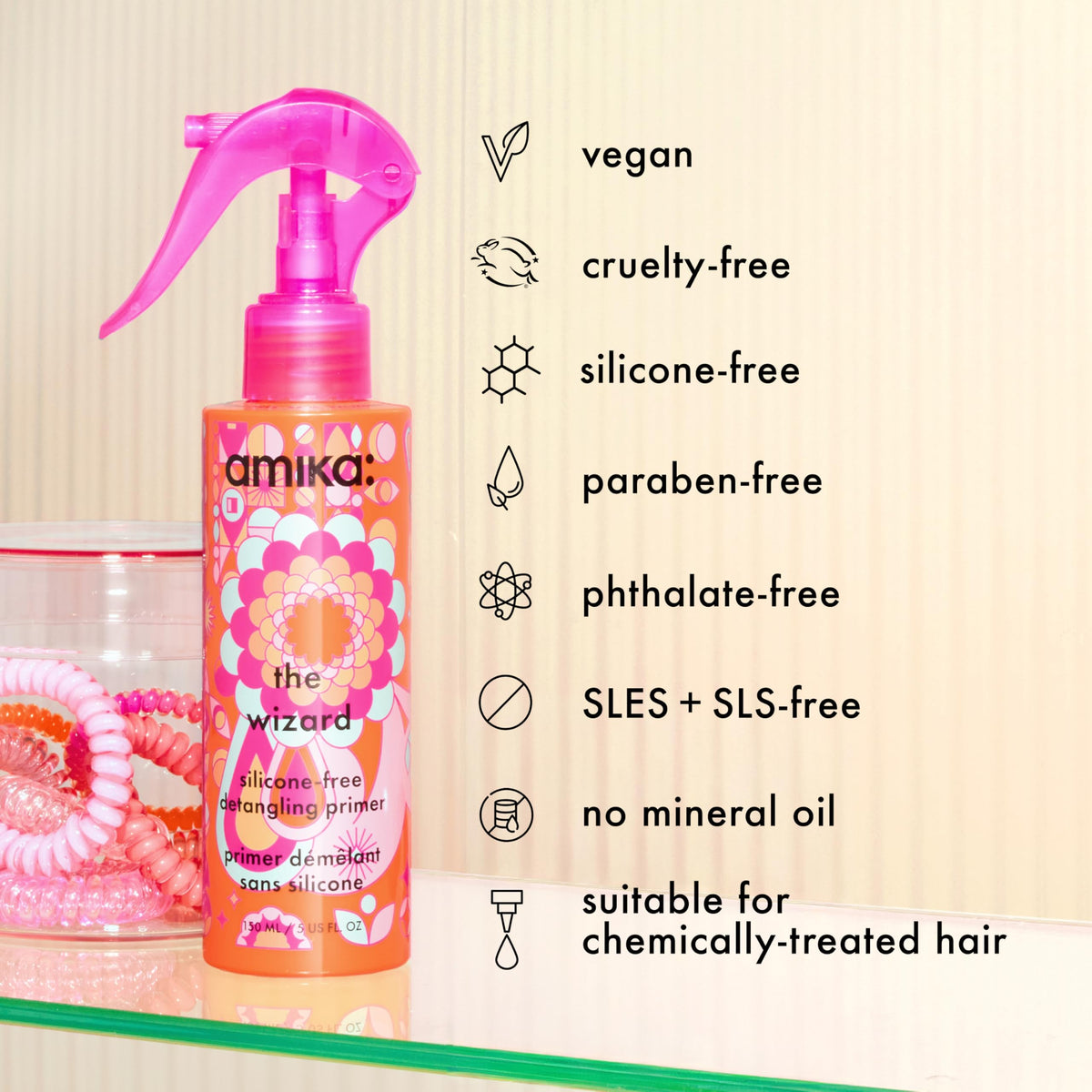 Amika bottle held in hand for size comparison and travel-friendly benefit
