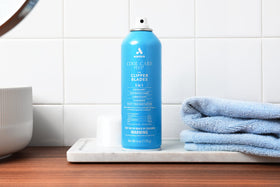 Andis Cool Care Plus can next to clippers showing compact 6 oz size