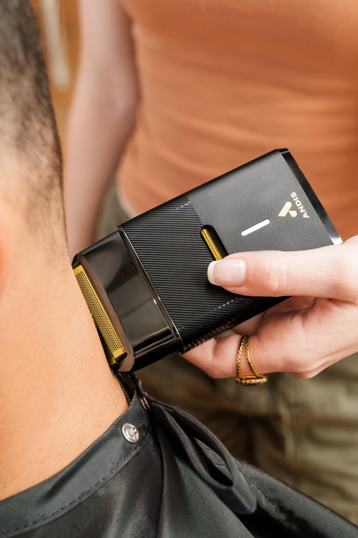 Andis shaver side grip detail displaying textured handle for secure control during use