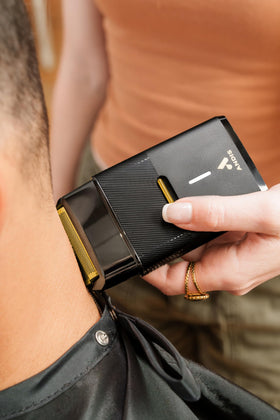 Andis shaver side grip detail displaying textured handle for secure control during use