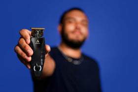 Andis GTX-EXO held in hand demonstrating clear blade visibility for detailing