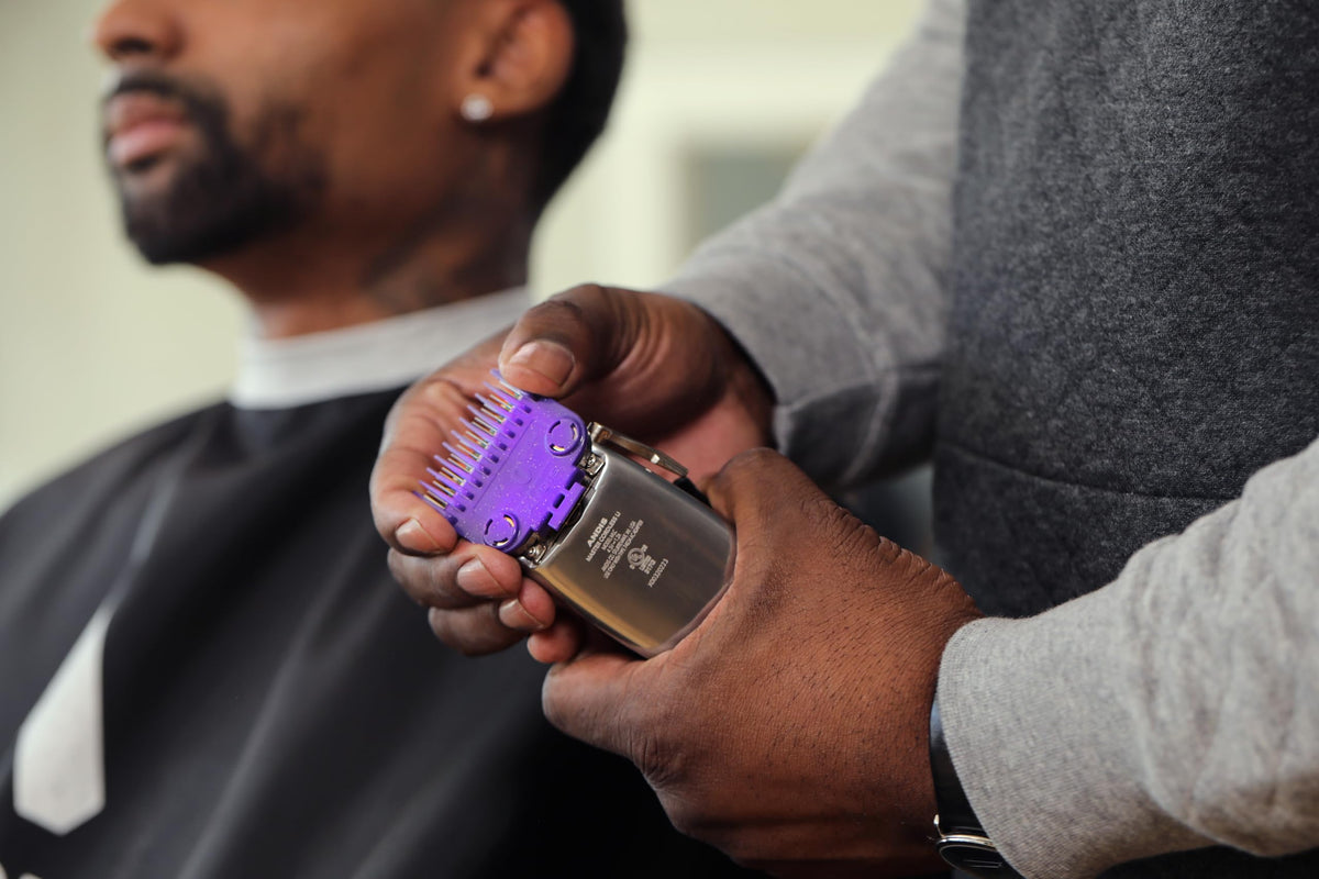 Andis comb attached to clipper in use delivering stable cuts and reduced slipping