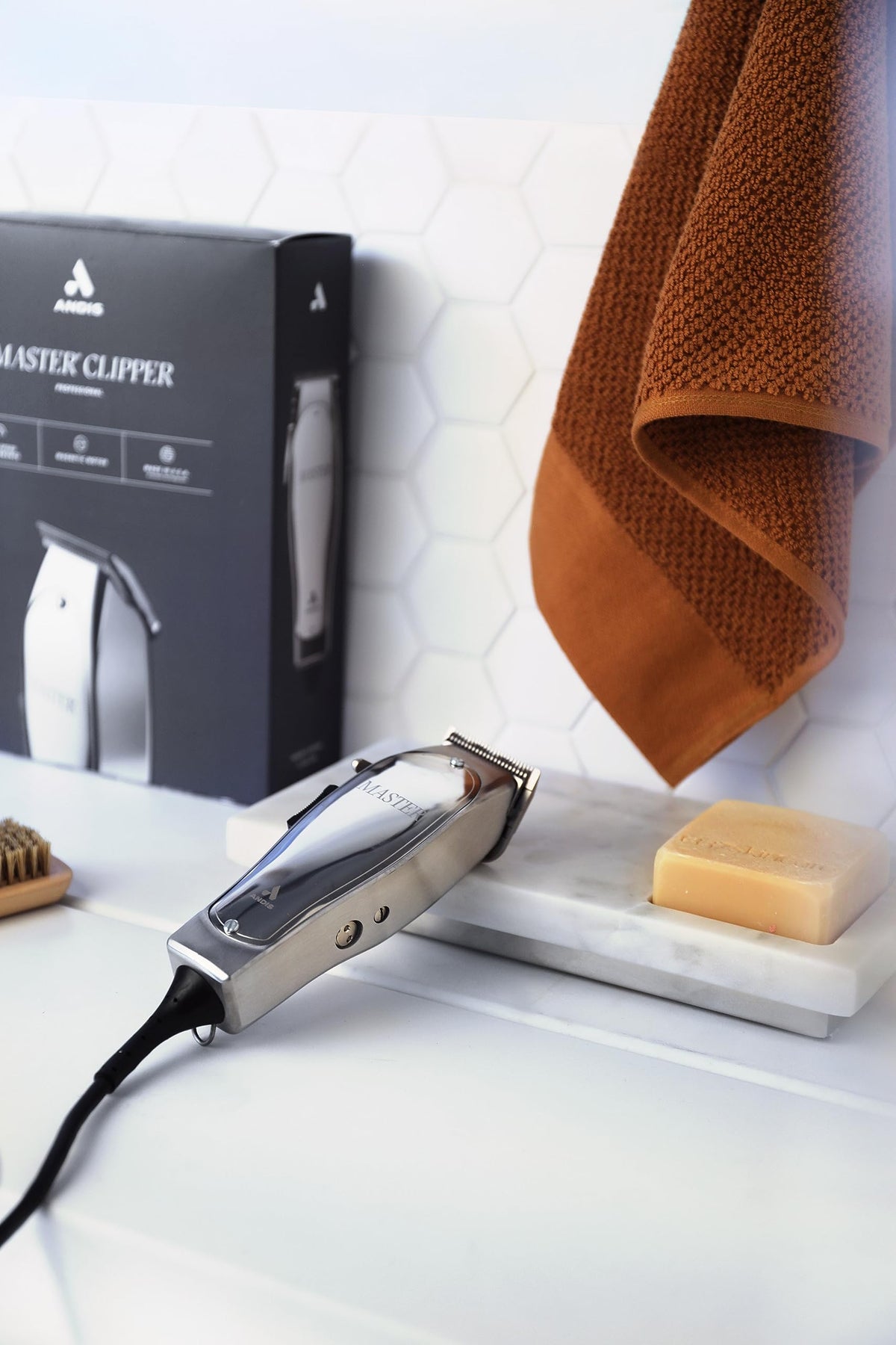 Andis held in hand to show compact scale and balanced weight for steady handling