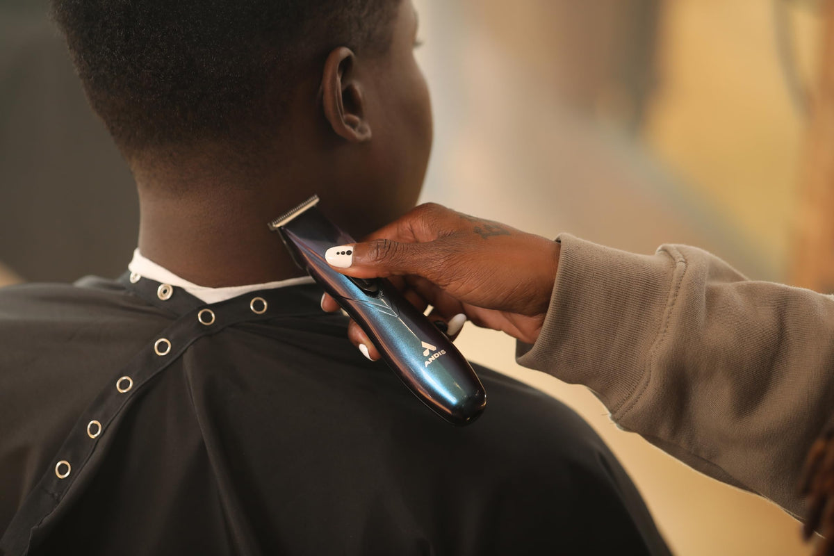 Andis Slimline Pro cord-free in stylist hand showing cordless freedom and control