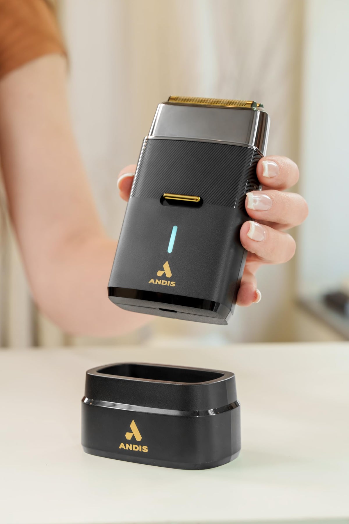 Andis USB-C charging stand pictured with shaver to show convenient rapid recharge