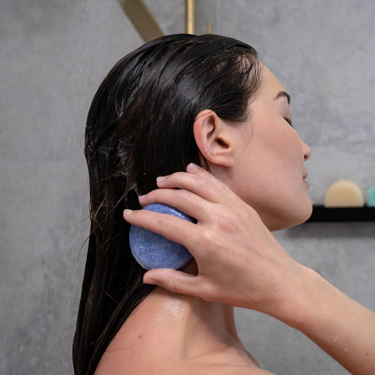 ANIHANA shampoo bar held in hand to show size and travel-friendly benefit