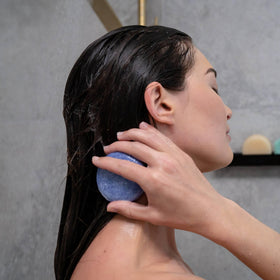 ANIHANA shampoo bar held in hand to show size and travel-friendly benefit