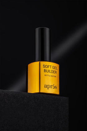 APRÉS bottle beside hand for scale showing travel-friendly professional size