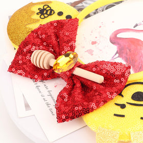 AQOKKA headband next to hand for scale showing size and wearable proportion