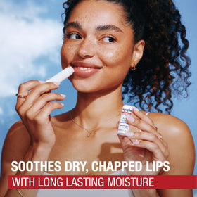 Aquaphor stick held in hand showing compact travel-friendly size