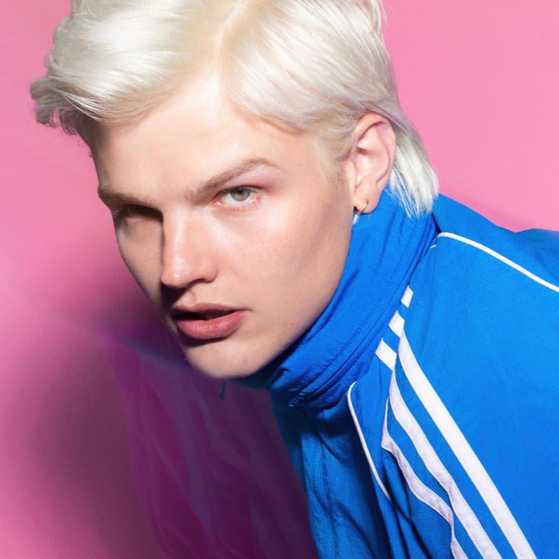 ARCTIC FOX bleach being applied to a hair strand demonstrating targeted root touch-up