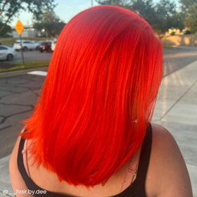 ARCTIC FOX applying Sunset Orange to hair strand showing vivid color payoff