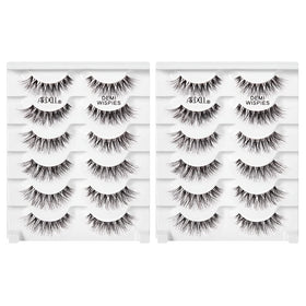 Ardell demi wispies next to fingertip showing compact size and fit