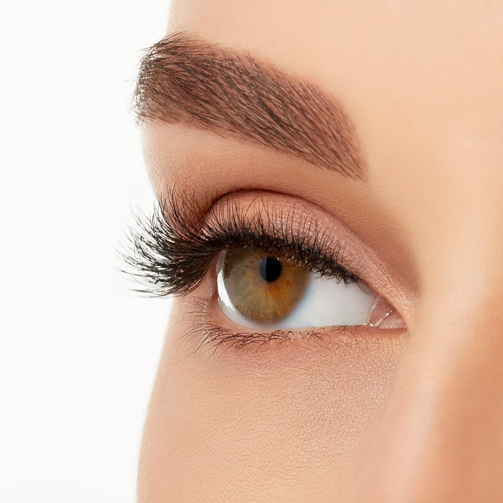 Ardell lashes beside a coin to show scale for accurate length