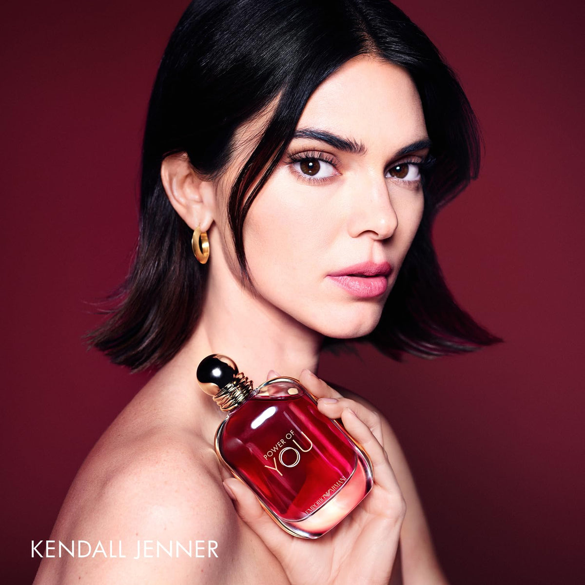 Armani Beauty bottle in hand for scale and ease-of-use visual reassurance
