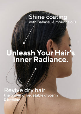 AROMATICA conditioner applied to hair mid-wash showing detangling benefit and smoother strands