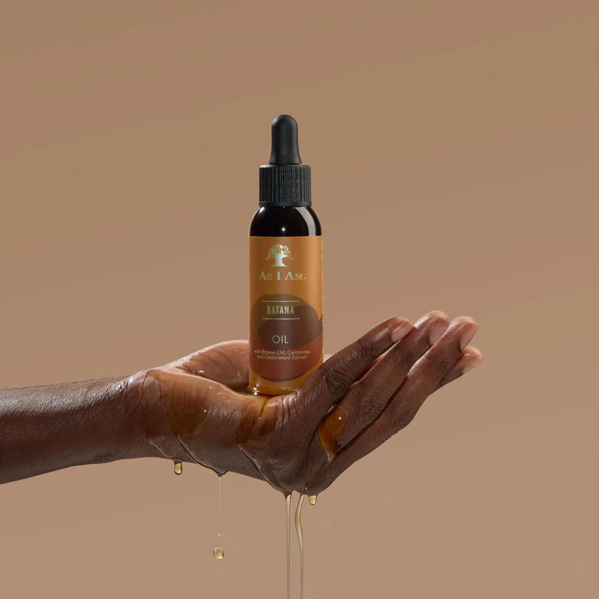 As I Am oil texture on hands demonstrating lightweight spreadability for easy use