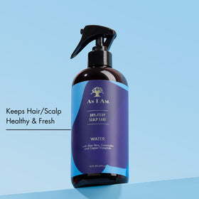 As I Am being sprayed on parted scalp illustrating targeted application benefit