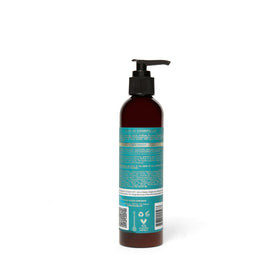 As I Am bottle held in hand showing 8 oz size and portability benefit