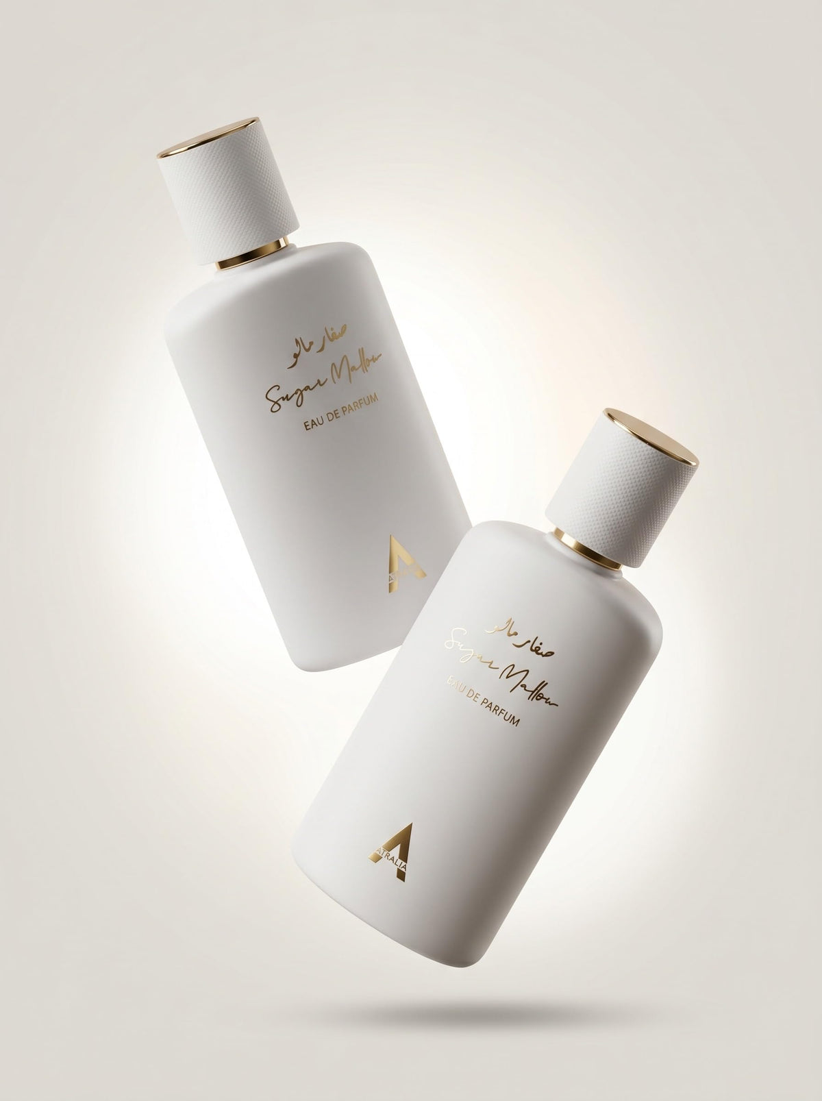 Atralia perfume beside marshmallow and strawberries showing sweet ingredients