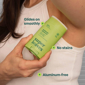 ATTITUDE deodorant held in hand to show compact 2.64 oz travel size