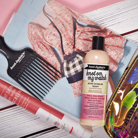 Applying Aunt Jackie's on damp curly hair to demonstrate easier combing and reduced pulling