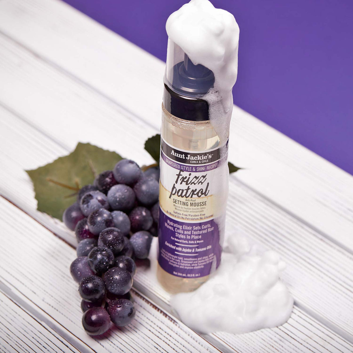Flatlay of grapeseed, jojoba, tamanu oils with Aunt Jackie's bottle showing natural oil benefits