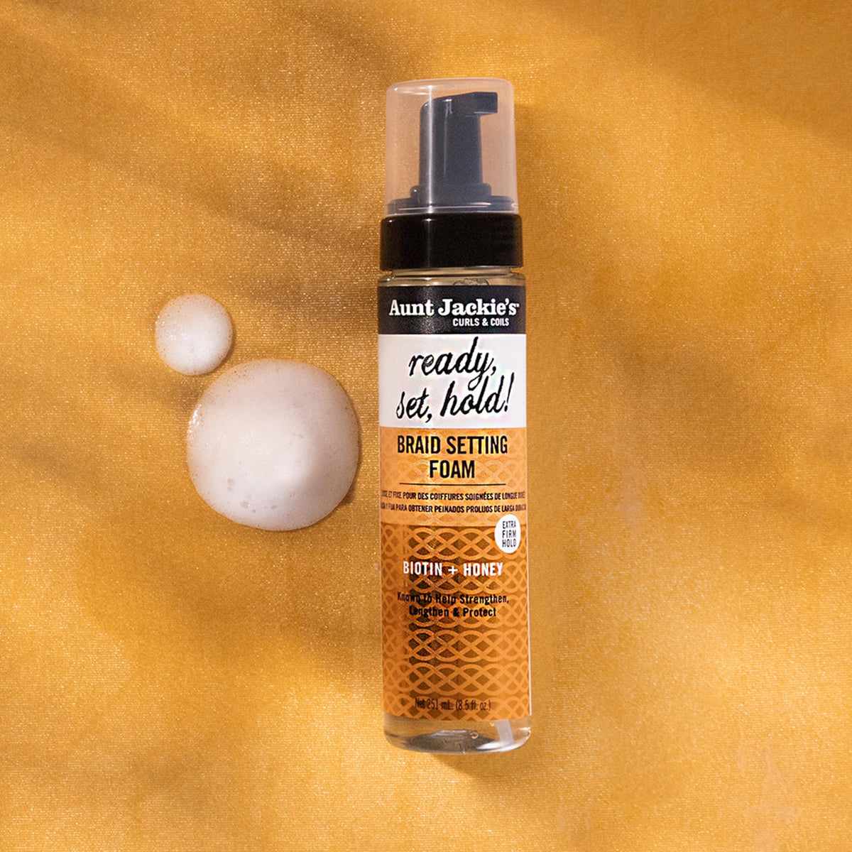 Close-up of Aunt Jackie's foam texture highlighting lightweight, non-greasy feel