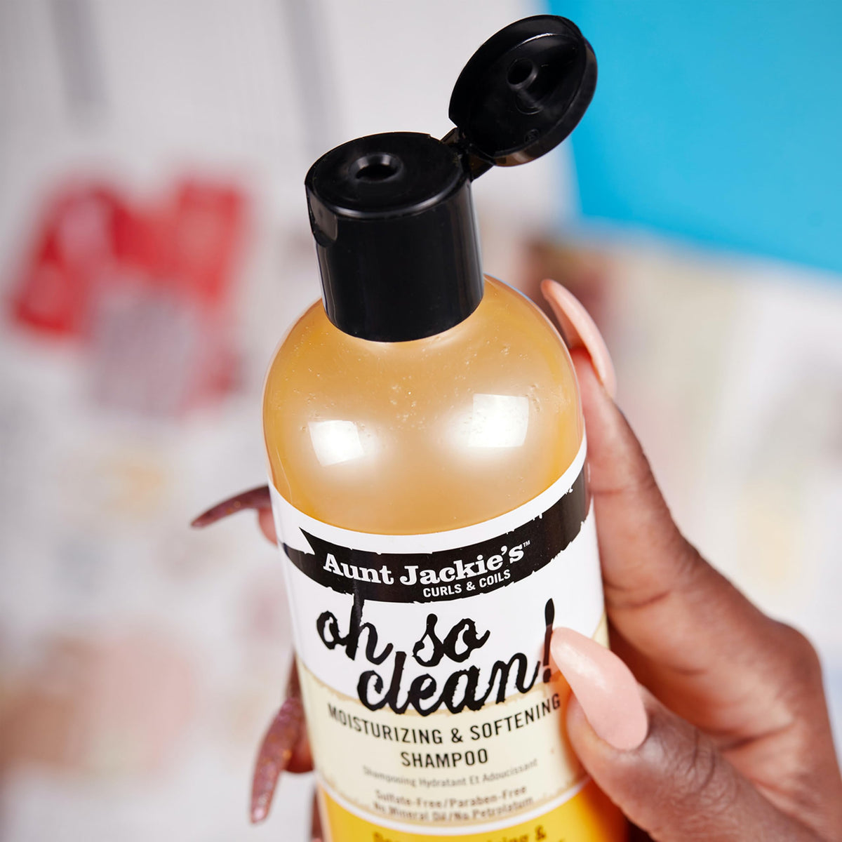 Shea butter, coconut oil, and olive oil near Aunt Jackie's bottle highlighting nourishing ingredients