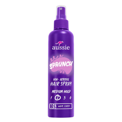Aussie hairspray front packaging showing three bottles and product branding benefit strong hold