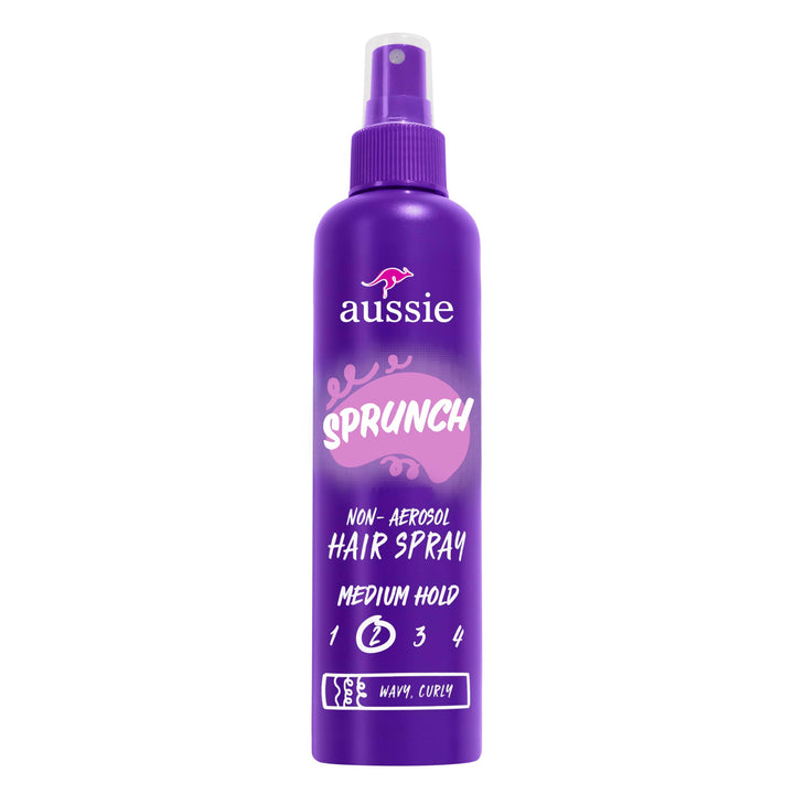Aussie hairspray front packaging showing three bottles and product branding benefit strong hold