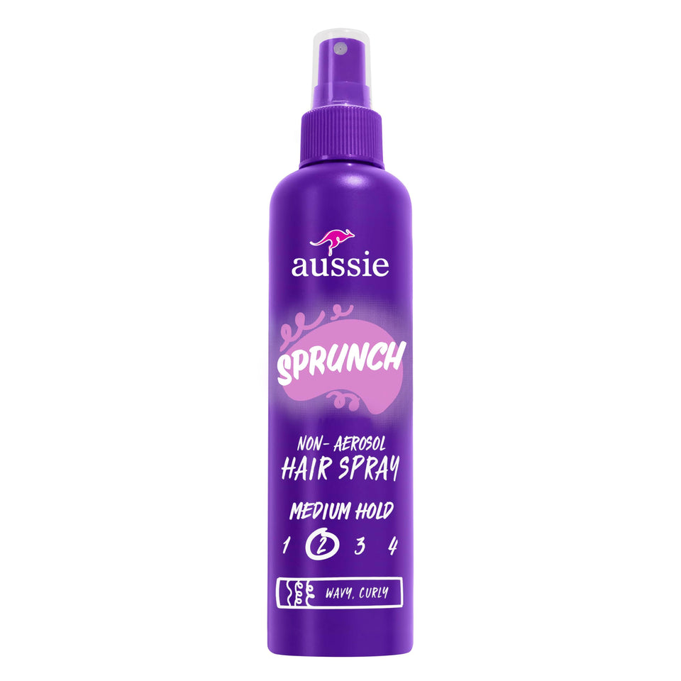 Aussie hairspray front packaging showing three bottles and product branding benefit strong hold