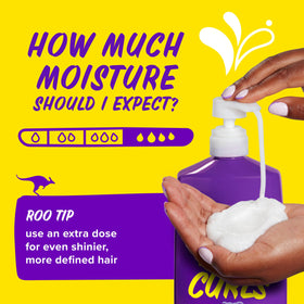 Model applying Aussie in shower to wet curls, highlighting ease of use and hydration