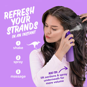 Aussie can on a bathroom counter with styling tools, suggesting quick morning touch-up benefit