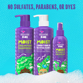 Child using Aussie kids detangler spray for easier brushing and fewer tangles