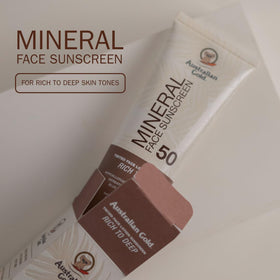 Australian Gold tube in hand showing 2.5 fl oz size for travel convenience