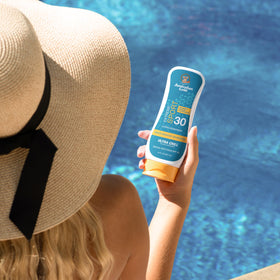 Australian Gold lotion applied to skin from bottle during outdoor activity for cooling relief