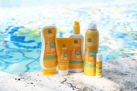 Australian Gold being applied at the beach for water-resistant outdoor protection