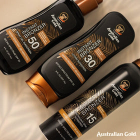 Australian Gold next to hand for scale to show 8 ounce bottle size