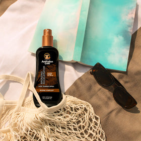 Australian Gold spray in hand demonstrating even application benefit