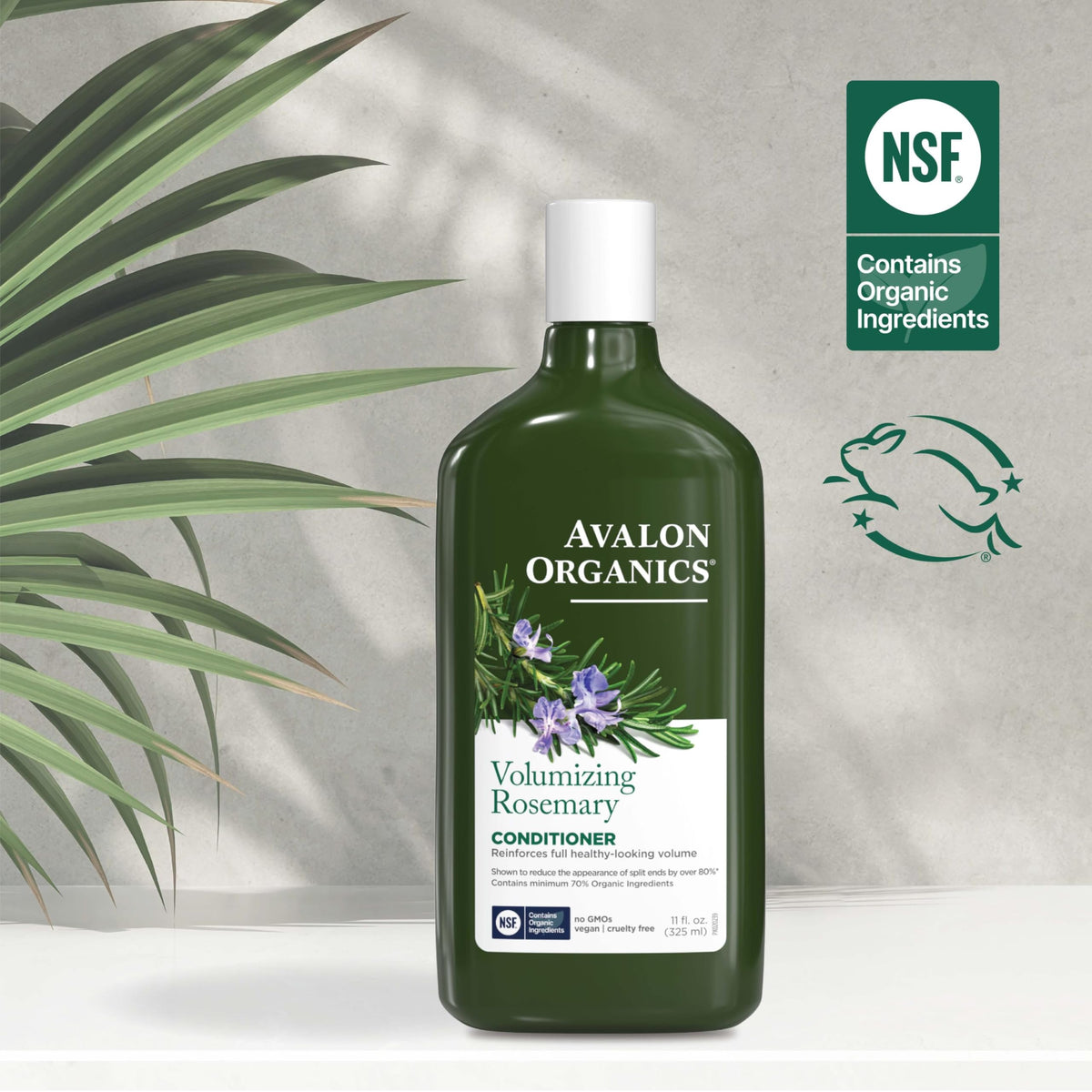 Hand holding Avalon Organics 11 oz bottle for size comparison benefit