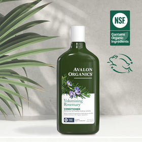 Hand holding Avalon Organics 11 oz bottle for size comparison benefit