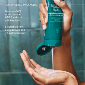 Aveda 1.4 fl oz bottle next to hand to show travel-friendly size and portability