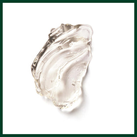 Aveda Brilliant jar on bathroom counter with towel, lifestyle scene conveys daily styling ease