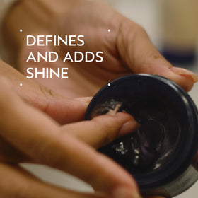 Aveda Brilliant pomade texture close-up in jar, shows creamy humectant formula benefit