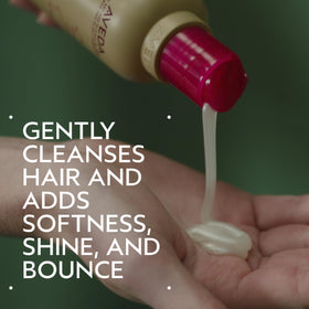 Aveda cherry almond pump dispensing shampoo texture, demonstrates creamy lather benefit